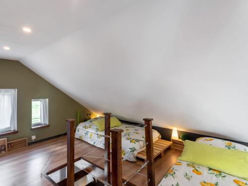 a bedroom with two bunk beds in a attic at Stylish Stay in Birresborn in Birresborn