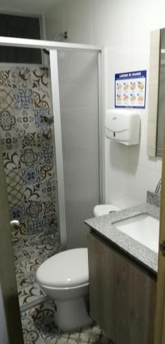 a bathroom with a toilet and a sink at Casa de verano in San Jerónimo