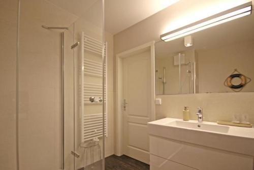 キュールングスボルンにあるHaus-Atlantik-Wohnung-3-16-98の白いバスルーム(シンク、シャワー付)