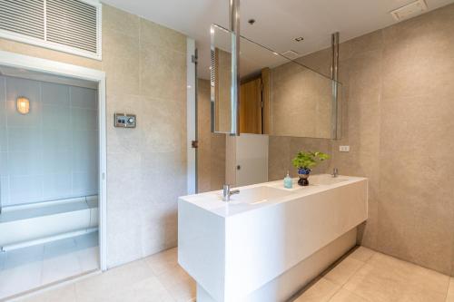 a bathroom with a white sink and a mirror at Residence By Hello Pattaya At Veranda in Jomtien Beach