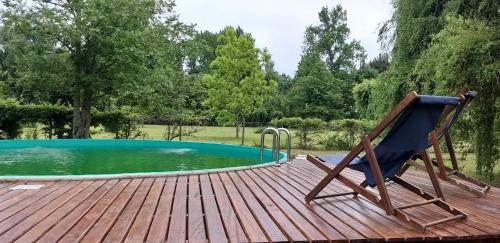 a chair sitting on a deck next to a swimming pool at Ensueño casa de isla in Tigre