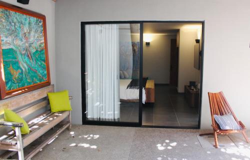 a room with a room with a bed and a mirror at Casa Olié in Oaxaca City