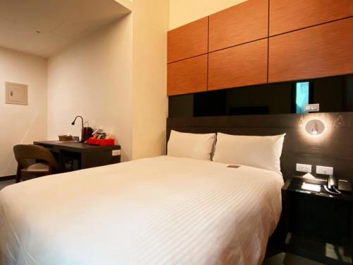 Postel nebo postele na pokoji v ubytování San Juan Easy Stay Inn Tainan