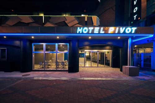 a hotel pivot with chairs in the windows at night at Hotel Pivot Shin-Imamiya Ekimae in Osaka
