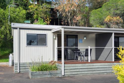 a small white house with a deck at Discovery Parks - Geelong in Geelong
