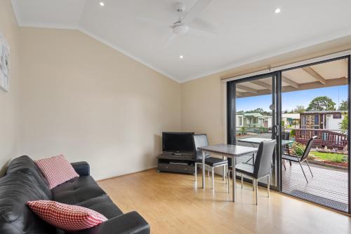 a living room with a couch and a table at Discovery Parks - Geelong in Geelong