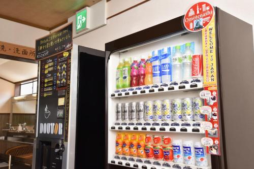 a vending machine filled with lots of bottles of soda at Kadokyu Ryokan in Takaoka