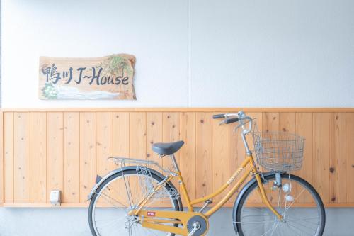 a bike parked in front of a wooden wall at Kamo River J~House in Kyoto