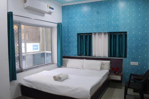 a bedroom with a large bed and a large window at TOURIST REST HOUSE in Rishīkesh