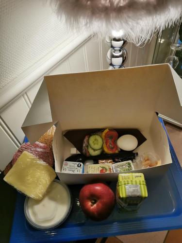 a box of food sitting on a blue table at Karlshamn Vandrarhem och Hotell in Karlshamn