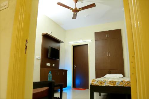 a bedroom with a bed and a ceiling fan at Lakeview Residency, Sricity TADA in Tada