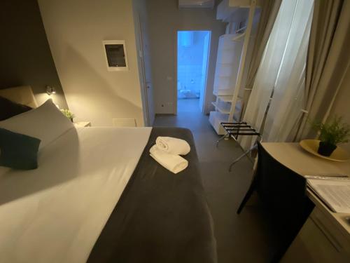 a hotel room with a bed with two towels on it at Lo Stallone -Malpensa Milan airport in Buscate