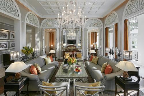a living room with a couch and a chandelier at Mandarin Oriental Bangkok - SHA Extra Plus in Bangkok