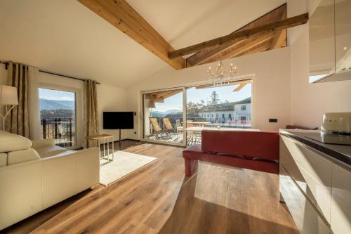 a kitchen and living room with a large window at berg und tal - schlosserhaus 31 in Tesimo