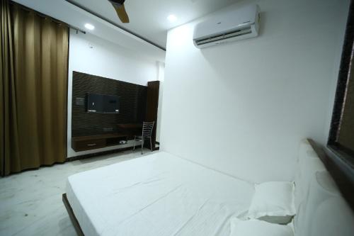 a bedroom with a bed and a tv in a room at Hotel Byke Ride - Walkable from Agra Cantt Railway Station in Agra