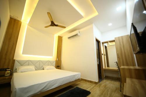 a bedroom with a white bed and a ceiling at Hotel Byke Ride in Agra