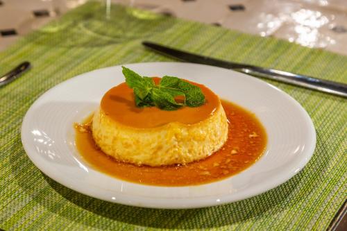 a white plate with a dessert on a table at Riad Tchaikana in Marrakech