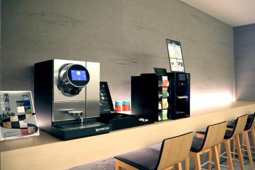 a barber shop with a cash register and chairs at Stay SAKURA Kyoto Fuga in Kyoto