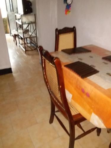 a wooden table and chairs in a room at Comfortable inn Green Sea Villa Helen, Kilometro 4 Circunvalar in San Andrés