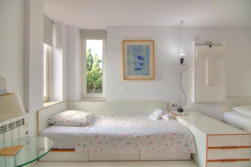 a bedroom with a bed and a desk and a window at Studio in the Red Wall building by Ricardo Bofill - MURALLA ROJA in Calpe