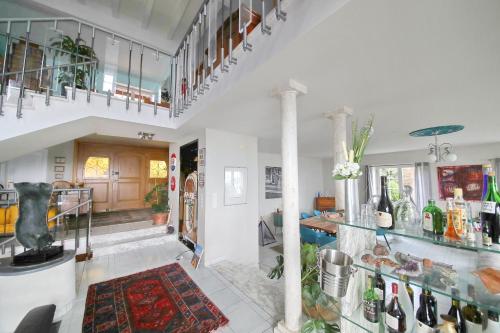 a living room with a staircase and a lobby at Corseaux Beach rooms-Riviera Beach apartments in Vevey