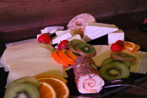 a plate of food with different types of fruit at Gasthaus Kempermann in Großenkneten