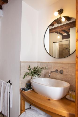 a bathroom with a white sink and a mirror at La Fattoria del Rio di Sopra - Agriturismo Baldeschi in Tuoro sul Trasimeno