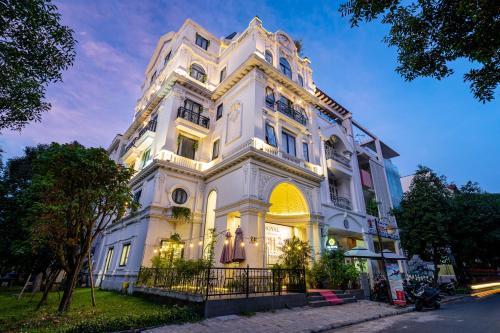 a large white building with lights on it at The Royal Hotel & Apartment - Phu My Hung in Ho Chi Minh City
