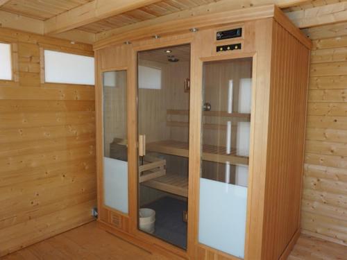 a sauna with glass doors in a wooden cabin at La Buisse in Simiane-la-Rotonde