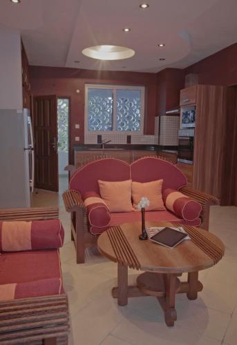 a living room with a couch and a table at Cowrie Shell Beach Apartments Official in Bamburi
