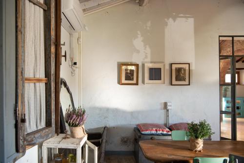 a living room with a table and a couch at La Fattoria del Rio di Sopra - Agriturismo Baldeschi in Tuoro sul Trasimeno
