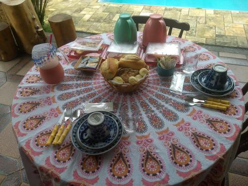 a table with a pink and white table cloth on it at Solar das Canoas Prumirim in Ubatuba