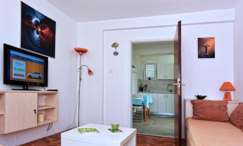 ein Wohnzimmer mit Sofa und Fernseher in der Unterkunft Apartment Gerber Krk in Krk