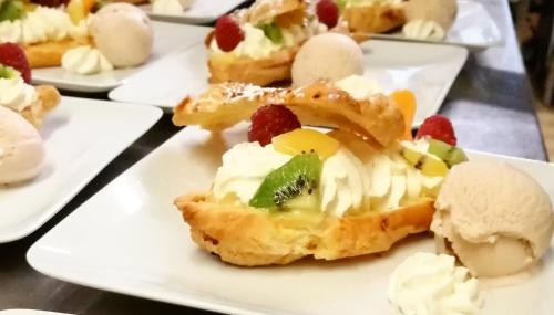 a plate of deserts with ice cream and fruit at Logis Hotel Xoko-Goxoa in Saint-Michel
