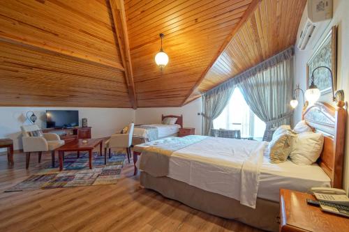 a bedroom with a large bed and a living room at My Marina Select Hotel in Datca