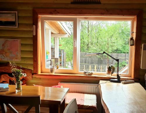 a living room with a table and a window at Kostel House in Mykulychyn