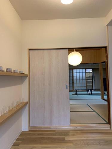 a sliding door in a room with a table at Kyoto Osaka SUMIREYA in Takatuki