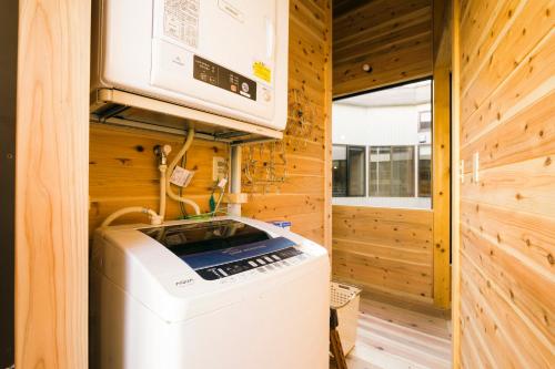 a washer and dryer in a tiny house at Ise Guest House Kazami in Ise