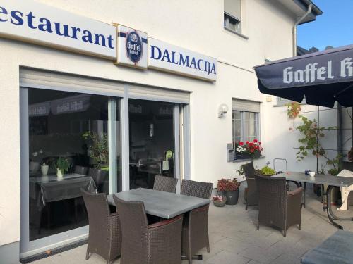 a table and chairs sitting outside of a restaurant at Hotel Restaurant Dalmacija in Gangelt