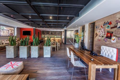 
a room filled with lots of wooden benches and plants at Mika Suites in Bogotá
