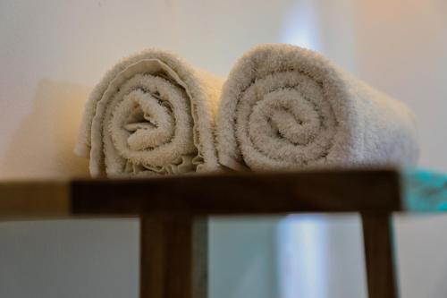 a towel on top of a wooden rack at Dan Stam Hotel in Arusha