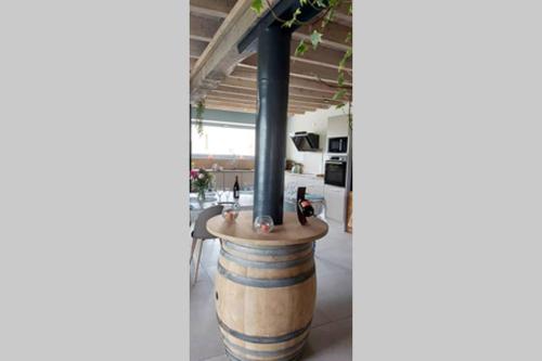 a barrel with a table in the middle of a room at Domaine de Solémy in Bully