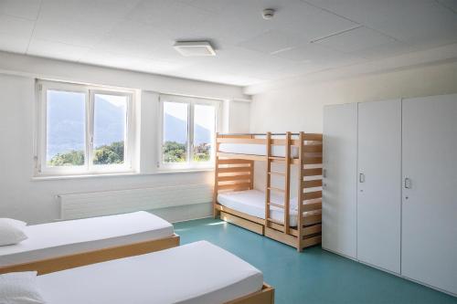 a room with two beds and a bunk bed at Casa San Bernardo in Contra