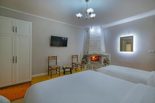 a bedroom with a bed and a fireplace at Vila 1 in Korçë