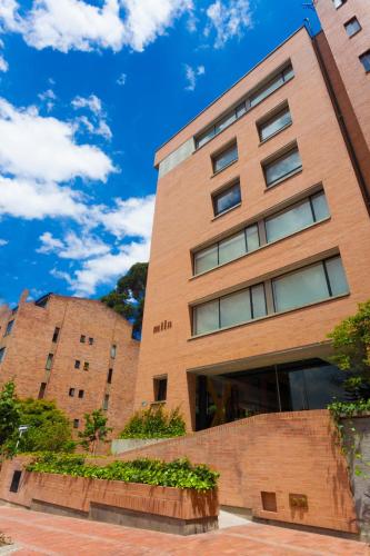 a brick building with a blue sky in the background at Mika Suites in Bogotá