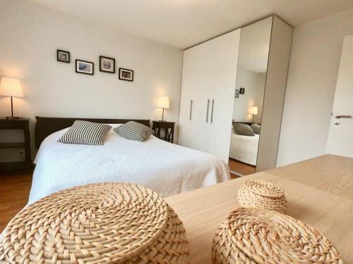 a bedroom with two beds and a large mirror at Modern, bright and spacious 3 bedrooms 2 bathrooms in Lausanne