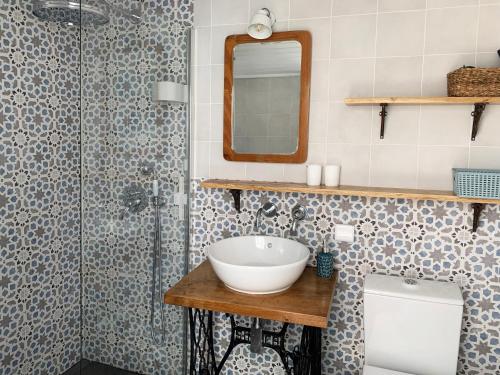 a bathroom with a sink and a shower at Casa Pescador Peniche in Peniche