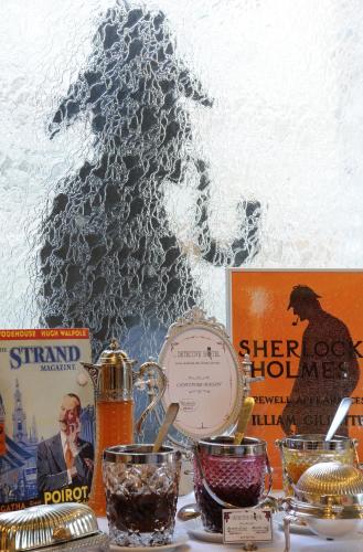 a table with some food and other items on it at Detective Hotel in Étretat