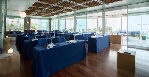a large room with blue tables and chairs at InterContinental Cascais-Estoril by IHG in Estoril