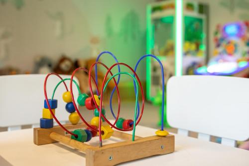a wooden toyousel with balls in a play room at Mercure Karpacz Skalny in Karpacz